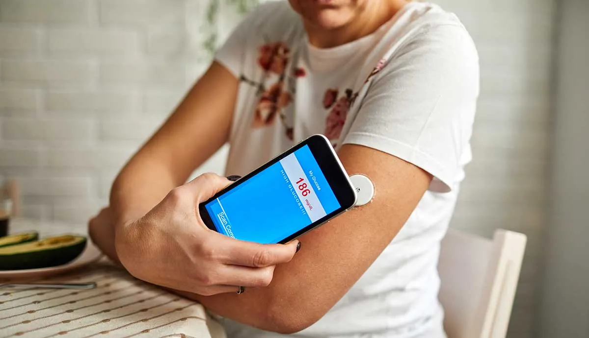 female checking her glucose levels