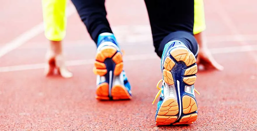 A professional runner preparing for the start on the start line